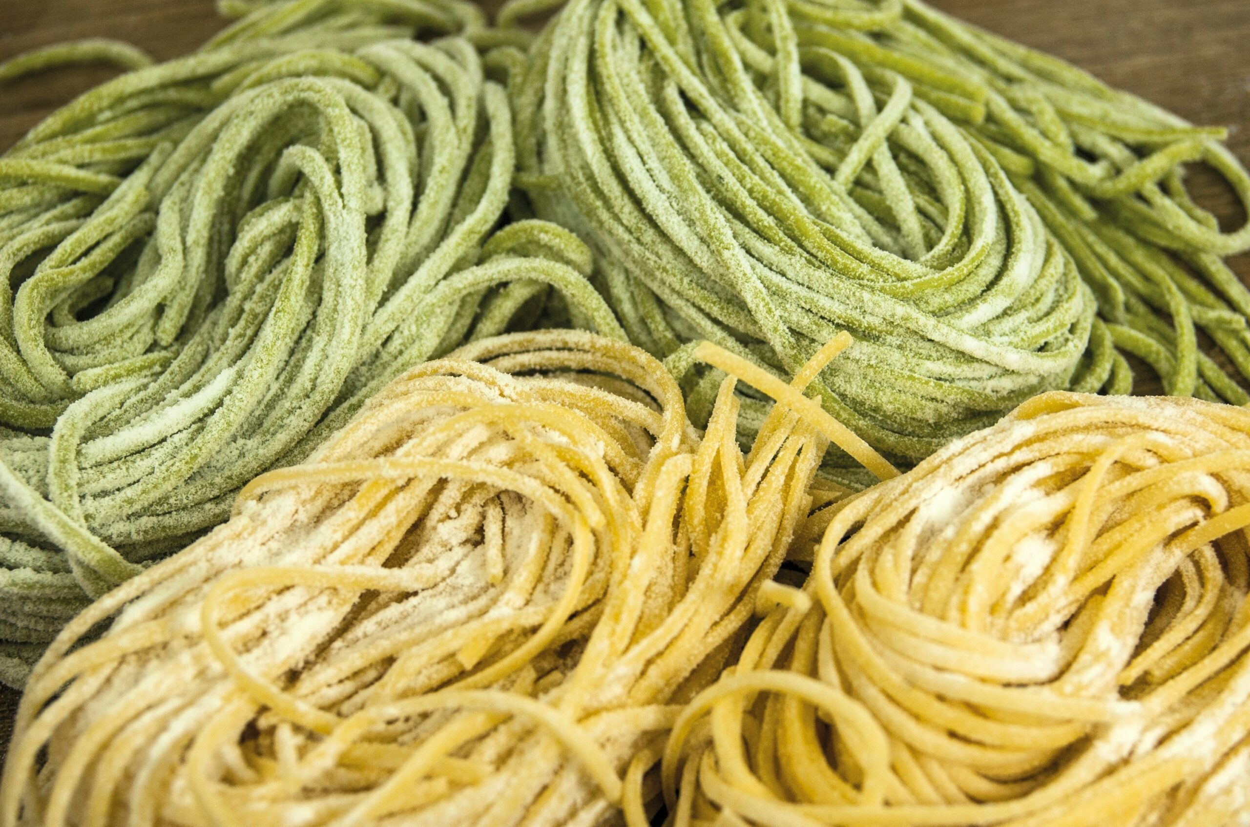 Image of green and yellow bundles of uncooked fresh spaghetti