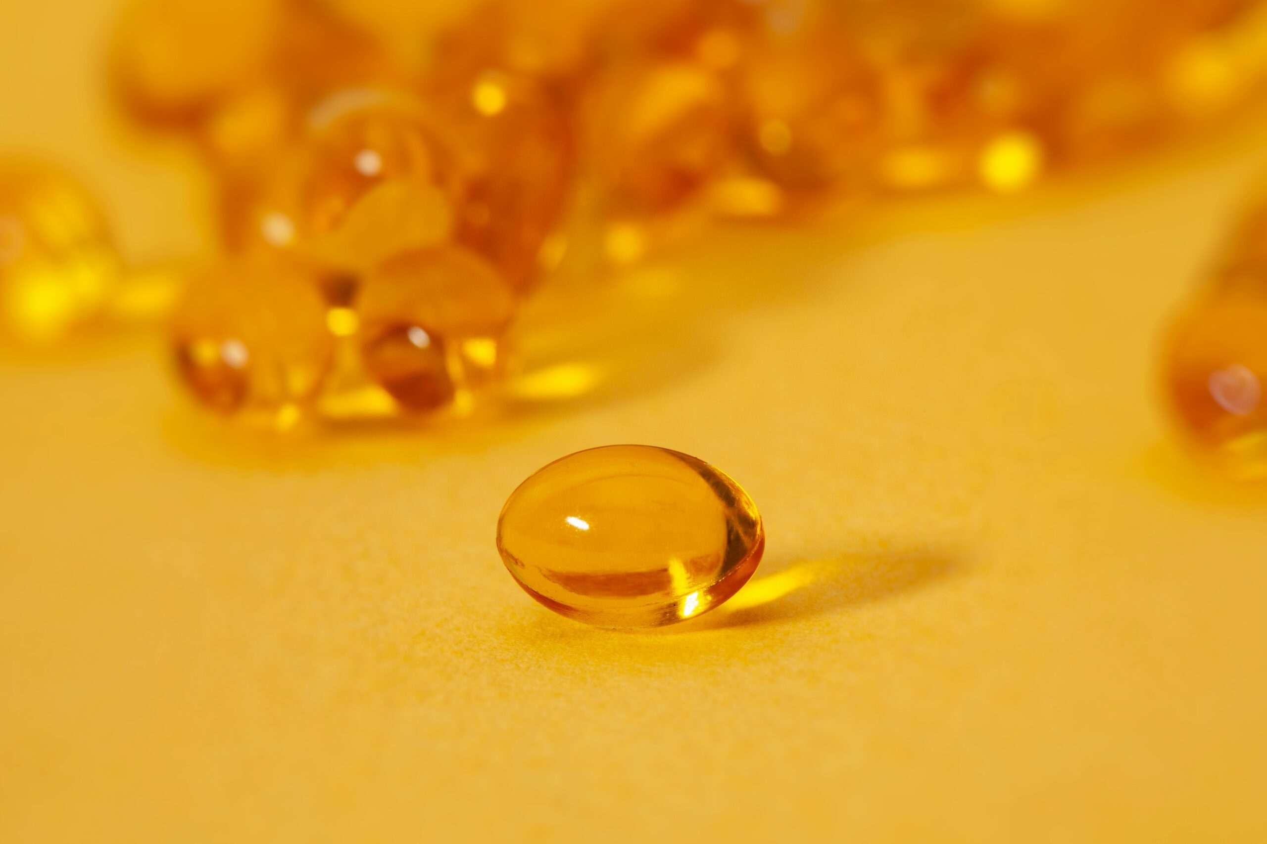 Image of some golden liquid filled capsules